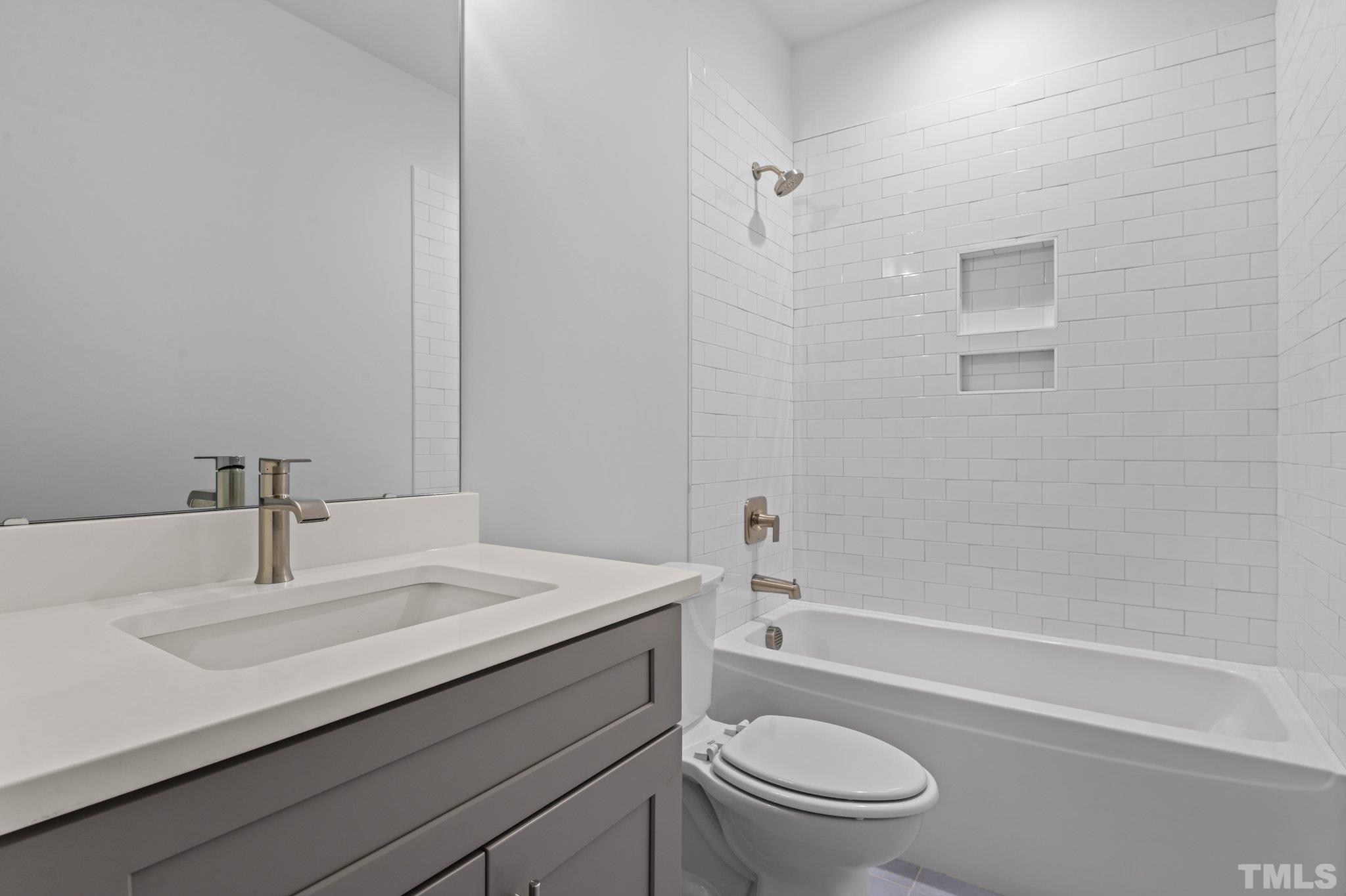 1019 Glascock Street Raleigh, NC 27610 - Photo 18 of 30 a bathroom with a sink a toilet and shower