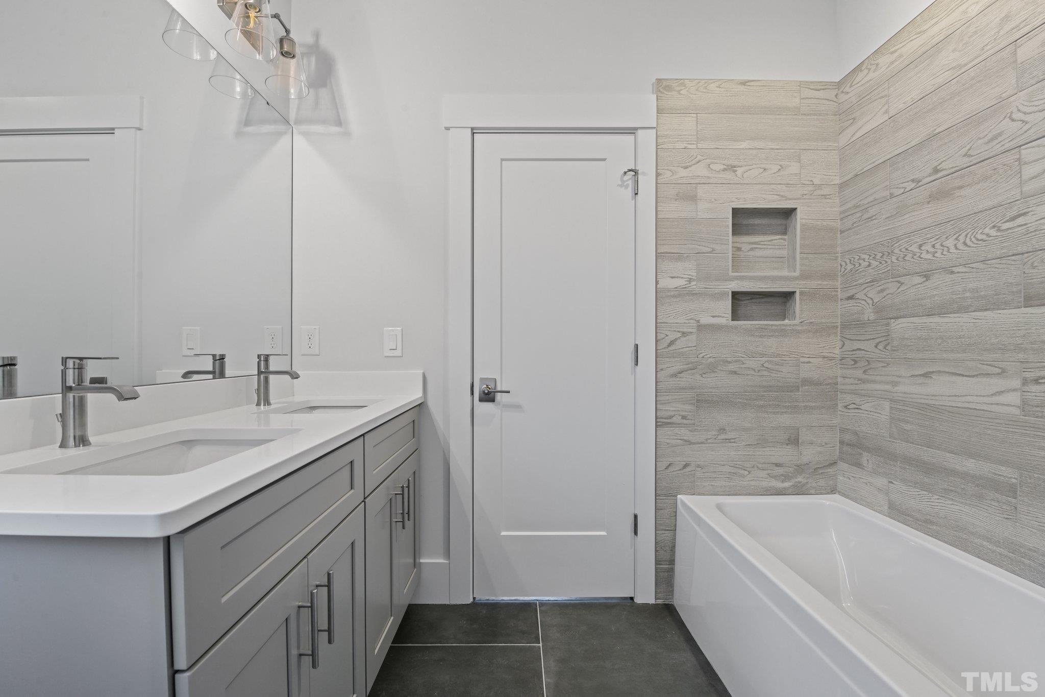1019 Glascock Street Raleigh, NC 27610 - Photo 21 of 30 a bathroom with a tub sink and mirror
