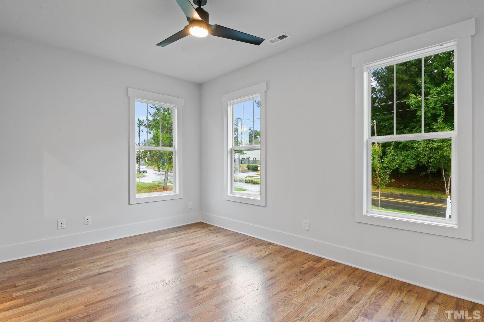1019 Glascock Street Raleigh, NC 27610 - Photo 23 of 30 a view of an empty room with wooden floor and a window