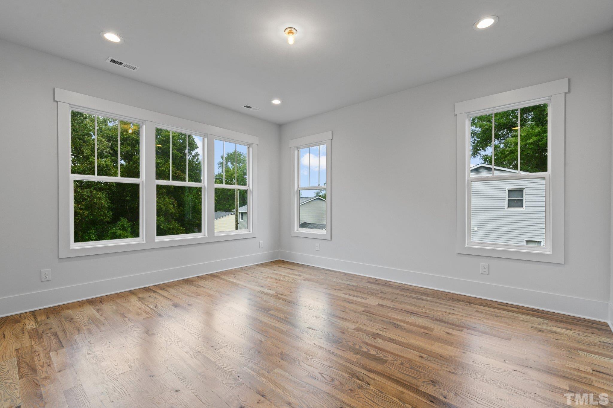 1019 Glascock Street Raleigh, NC 27610 - Photo 25 of 30 a view of an empty room with wooden floor and a window