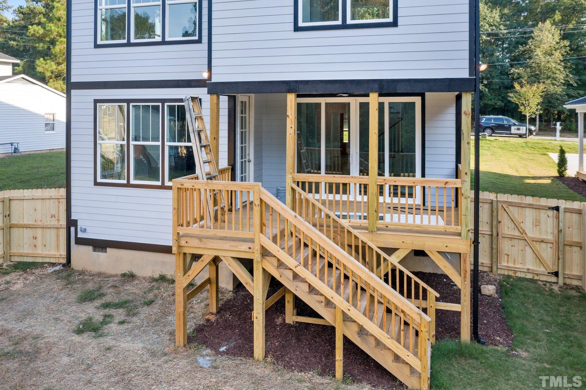 1019 Glascock Street Raleigh, NC 27610 - Photo 6 of 30 a view of a house with a small yard and a wooden deck