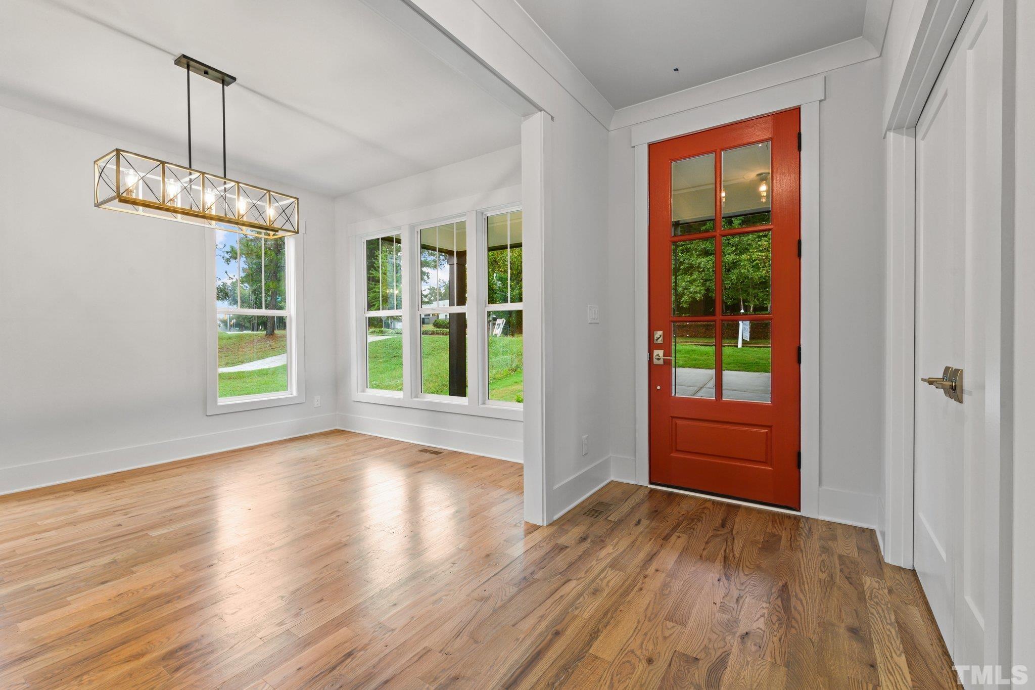 1019 Glascock Street Raleigh, NC 27610 - Photo 7 of 30 a view of room with window wooden floor and front door