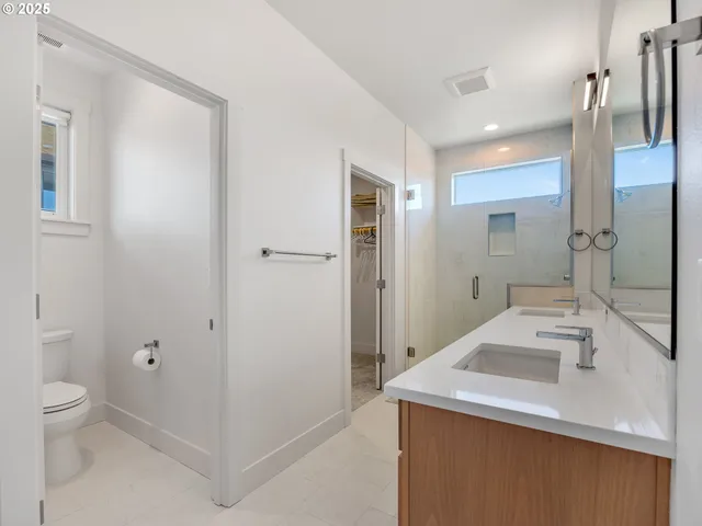 a bathroom with a granite countertop sink mirror and double