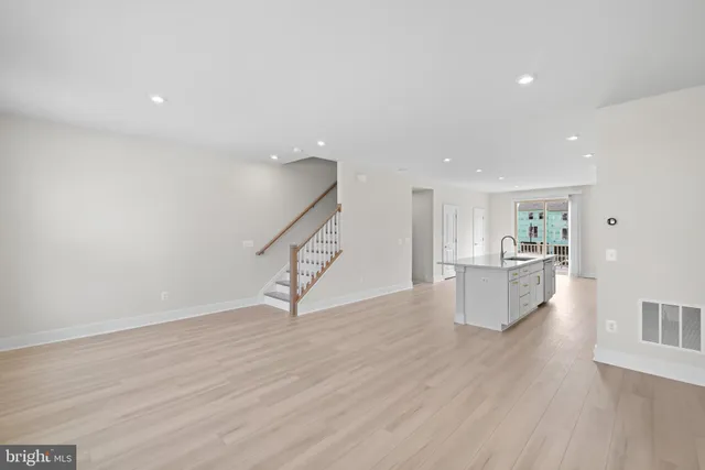 a kitchen with stainless steel appliances white cabinets and a refrigerator