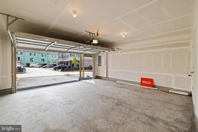 a view of kitchen with stainless steel appliances refrigerator stove microwave and cabinets