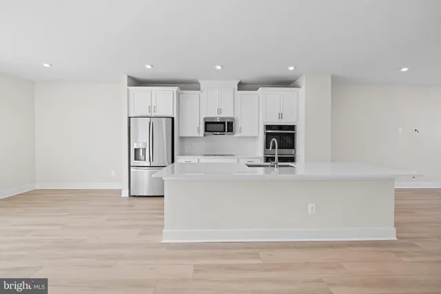 a view of kitchen with stainless steel appliances refrigerator microwave and stove