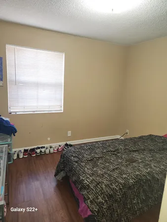 a bedroom with a bed and two mirrors