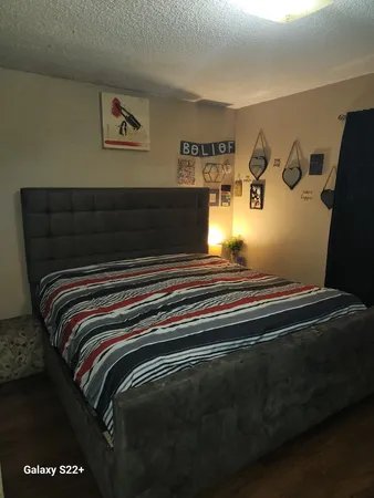 a bedroom with a bed and a dresser