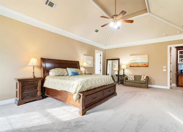 a bedroom with a bed and ceiling fan