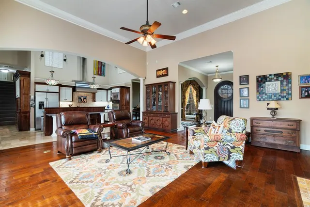 a living room with furniture and wooden floor