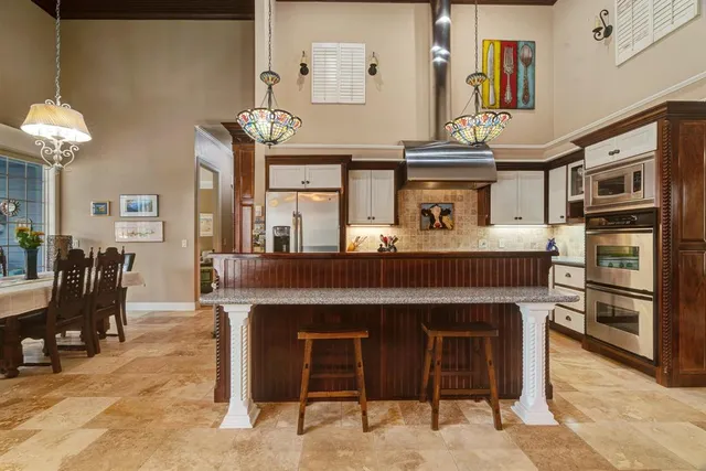 a kitchen with a cabinets and chandelier