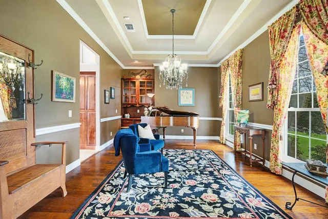 a living room with furniture and a chandelier