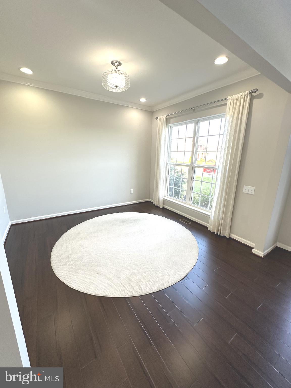 211 Arrowood Drive Smyrna, DE 19977 - Photo 4 of 22 an empty room with wooden floor and windows