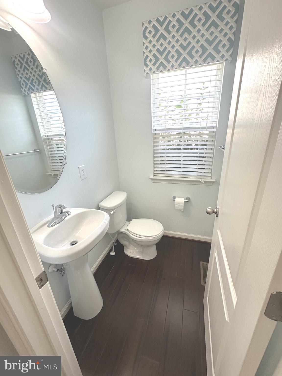 211 Arrowood Drive Smyrna, DE 19977 - Photo 5 of 22 a bathroom with a toilet sink and mirror