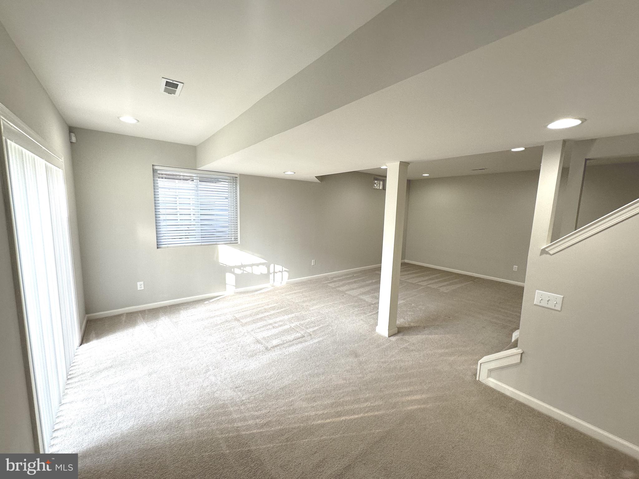 211 Arrowood Drive Smyrna, DE 19977 - Photo 10 of 22 an empty room with windows and pillars in it