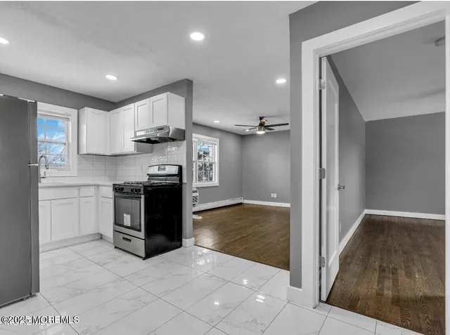 a kitchen with stainless steel appliances granite countertop a refrigerator and a sink