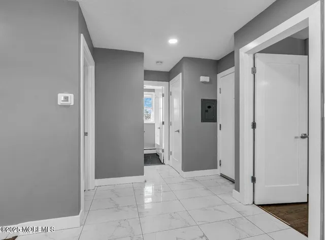 a view of a hallway with wooden shelves