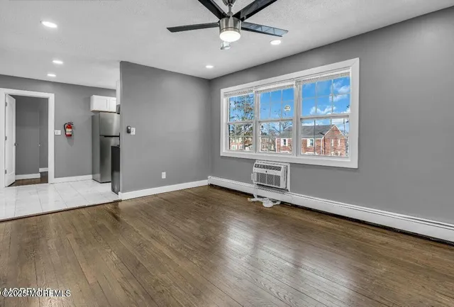 wooden floor in an empty room with a window