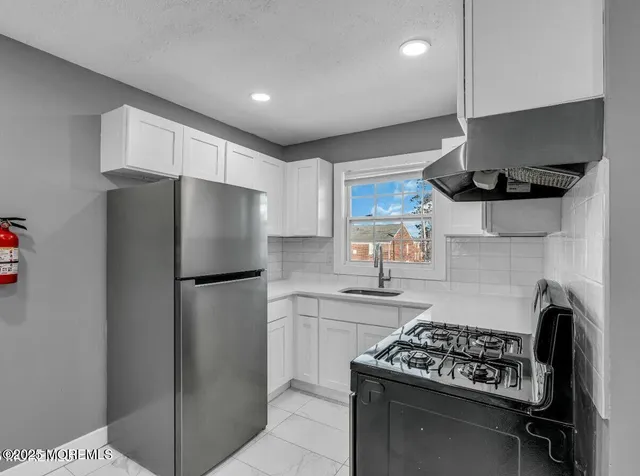 a kitchen with a stove and a refrigerator