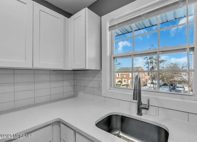 a kitchen with a sink and cabinets