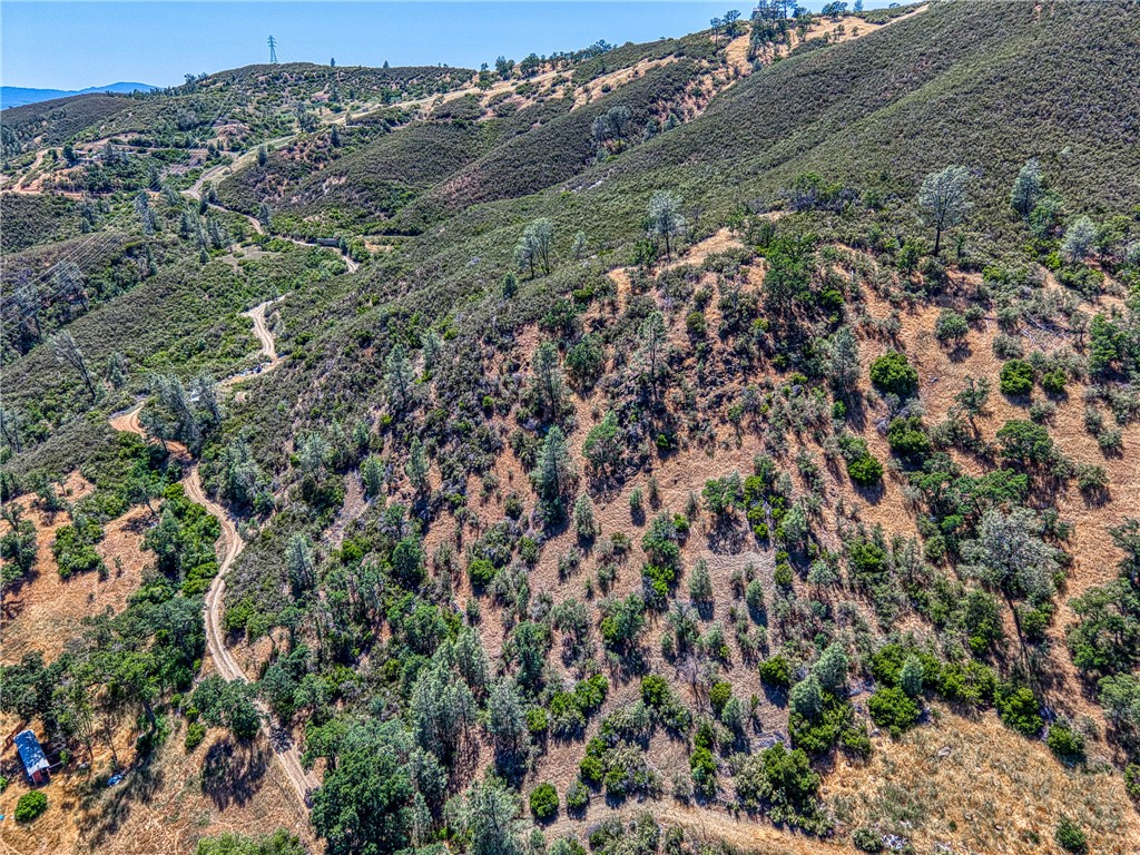 104 Mule Skinner Road Clearlake Oaks, CA 95423 - Photo 19 of 25 an aerial view of a houses with a lush green hillside