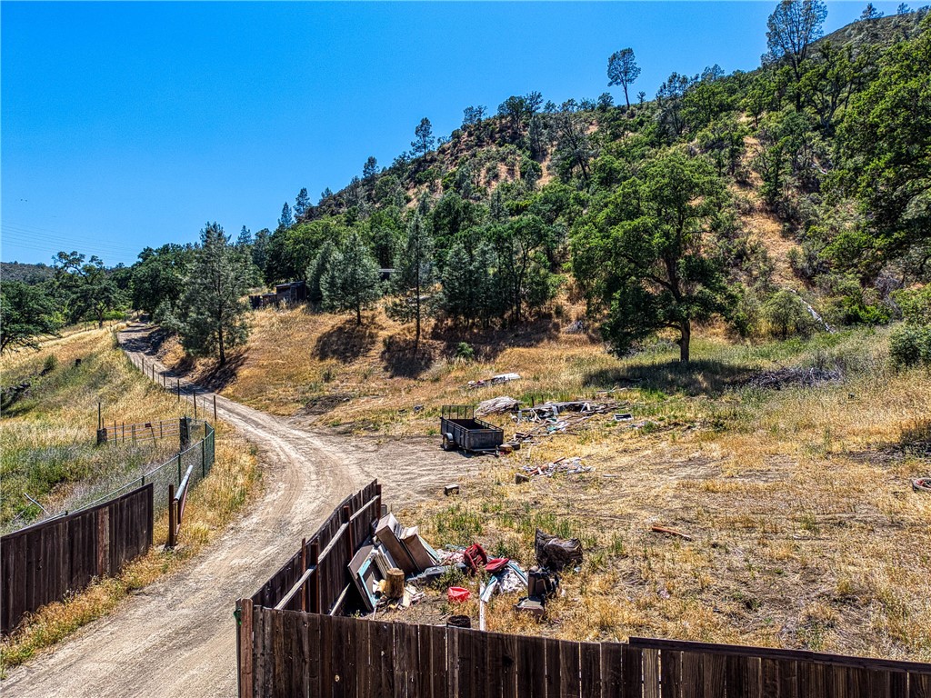 104 Mule Skinner Road Clearlake Oaks, CA 95423 - Photo 5 of 25 a view of a backyard with wooden fence