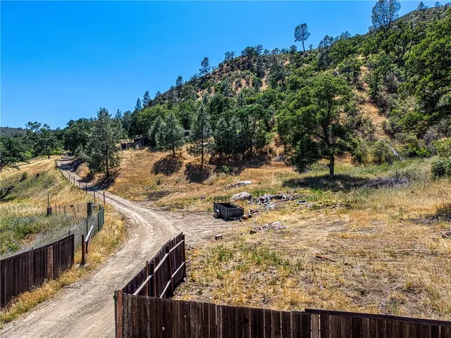 a view of a backyard with wooden fence