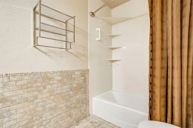 a bathroom with a bathtub and shower