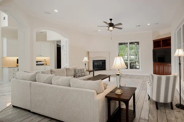 a living room with furniture a fireplace and a flat screen tv