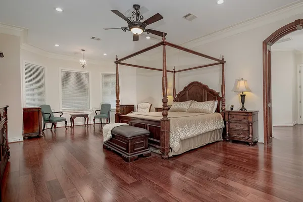 a bedroom with a bed furniture and wooden floor