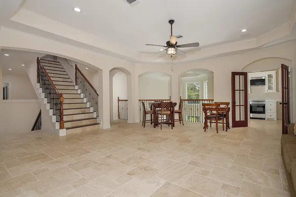 a view of an empty room with furniture and a ceiling fan
