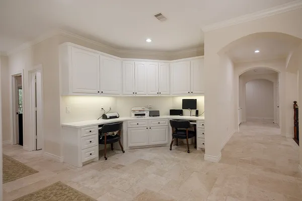 a kitchen with a stove top oven and white cabinets