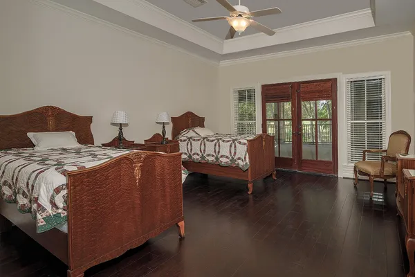 a spacious bedroom with a bed and a chandelier