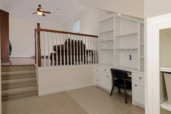 a hallway with cabinets and a window