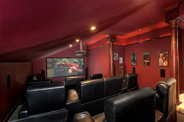 a room with furniture projector and screen