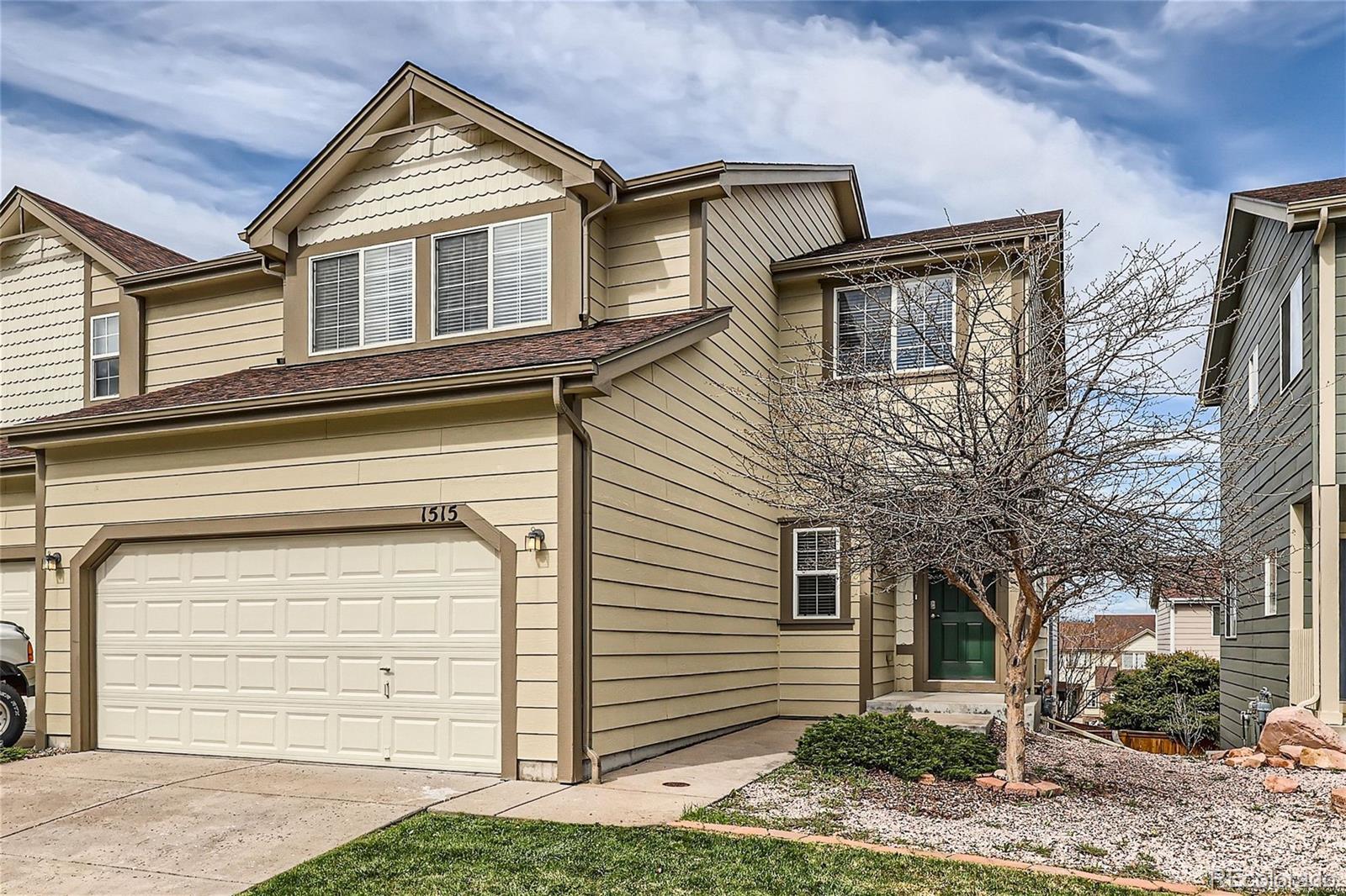 1515 Live Oak Road Castle Rock, CO 80104 - Photo 1 of 26 a front view of a house with a yard
