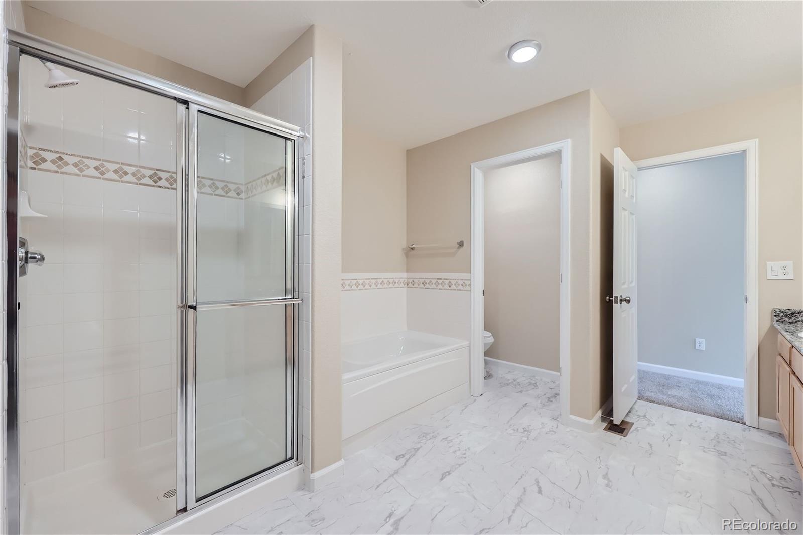 1515 Live Oak Road Castle Rock, CO 80104 - Photo 15 of 26 a bathroom with a glass shower door and a bathroom