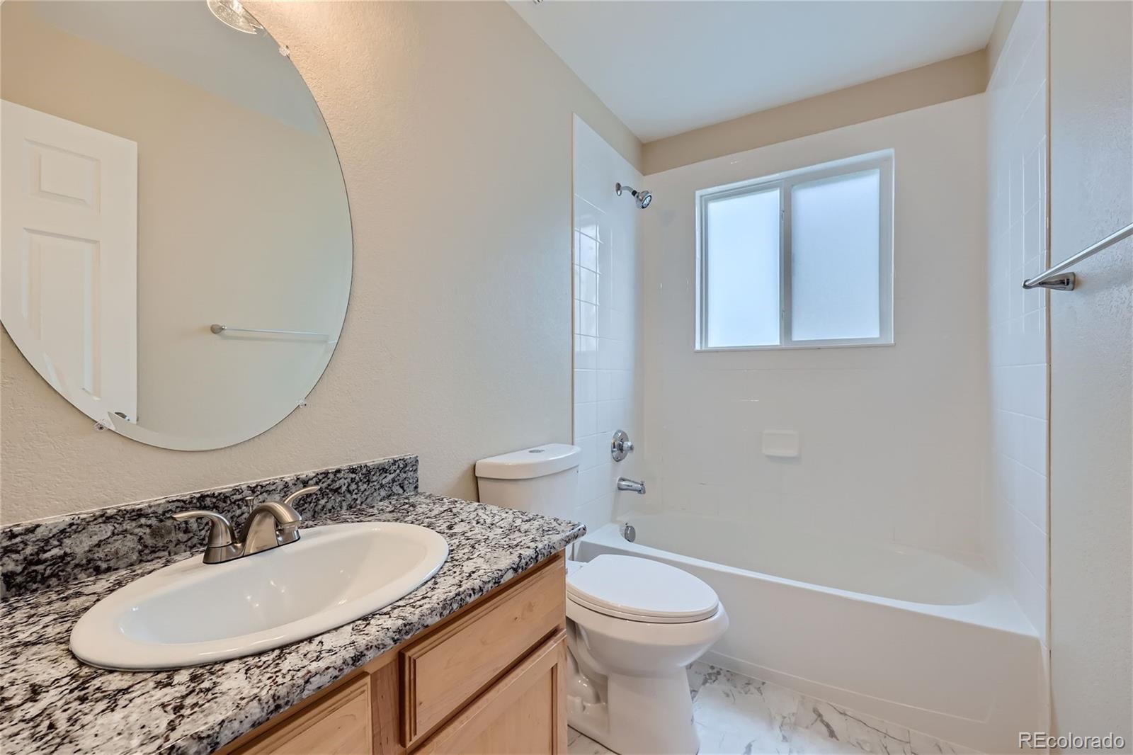 1515 Live Oak Road Castle Rock, CO 80104 - Photo 18 of 26 a bathroom with a sink a toilet and a mirror