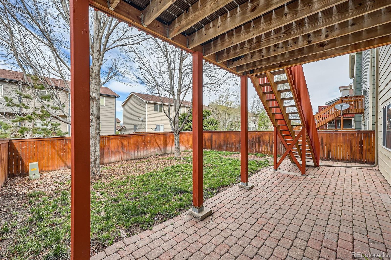 1515 Live Oak Road Castle Rock, CO 80104 - Photo 24 of 26 a porch area with trees in front of it
