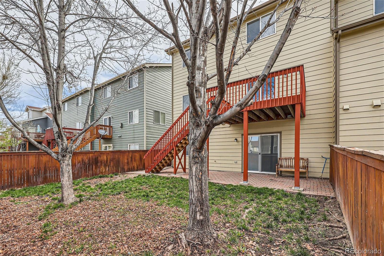 1515 Live Oak Road Castle Rock, CO 80104 - Photo 26 of 26 a backyard of a house with a tree beside it