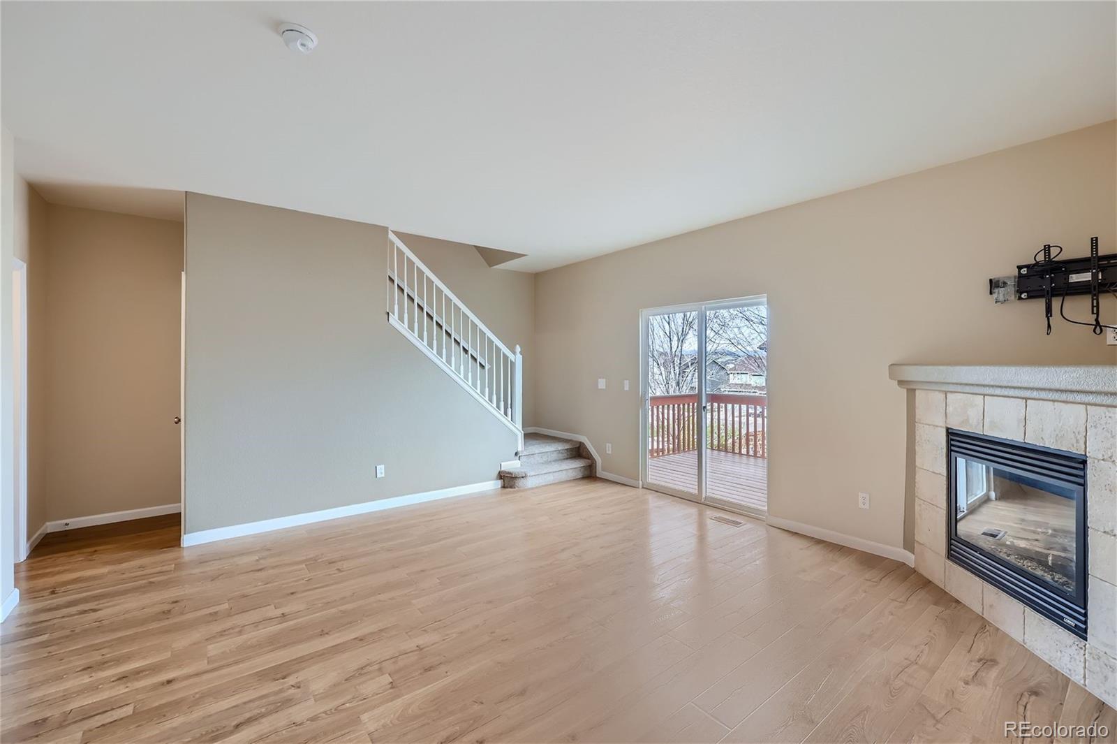 1515 Live Oak Road Castle Rock, CO 80104 - Photo 4 of 26 a view of an empty room with a window and fireplace