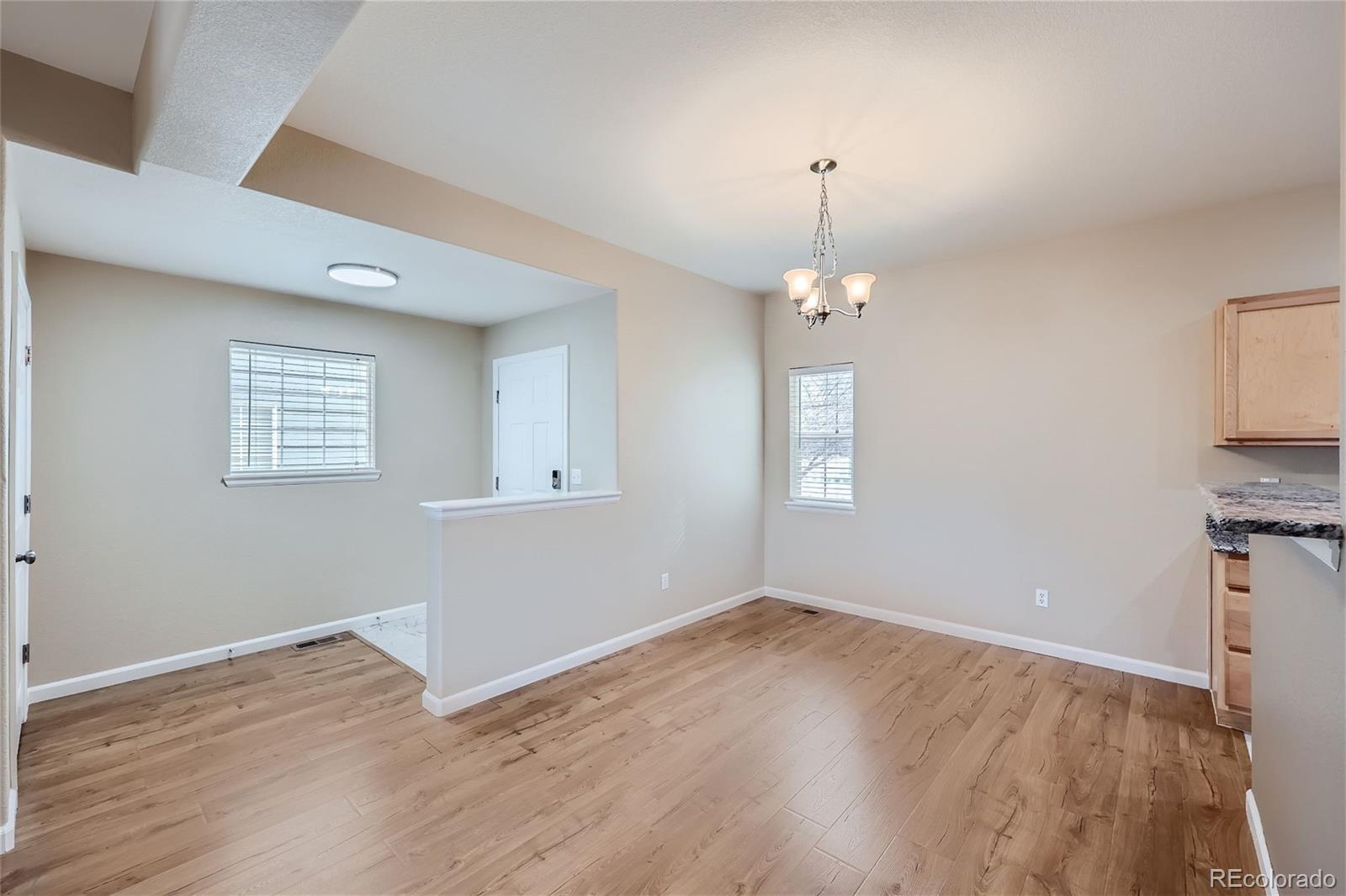 1515 Live Oak Road Castle Rock, CO 80104 - Photo 5 of 26 wooden floor in an empty room with a window