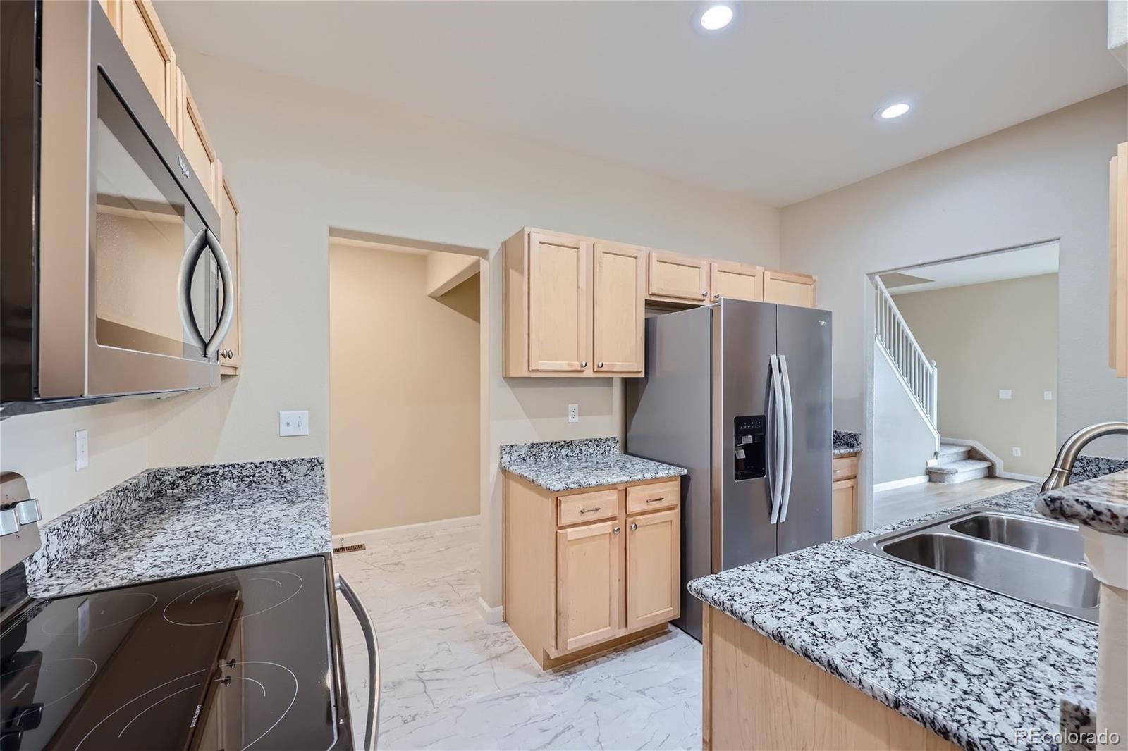 1515 Live Oak Road Castle Rock, CO 80104 - Photo 6 of 26 a kitchen with a sink stove and refrigerator