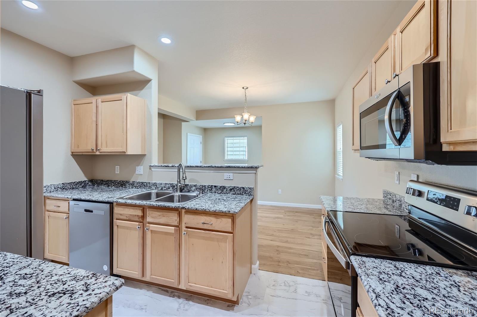 1515 Live Oak Road Castle Rock, CO 80104 - Photo 7 of 26 a kitchen with stainless steel appliances granite countertop a sink stove and cabinets