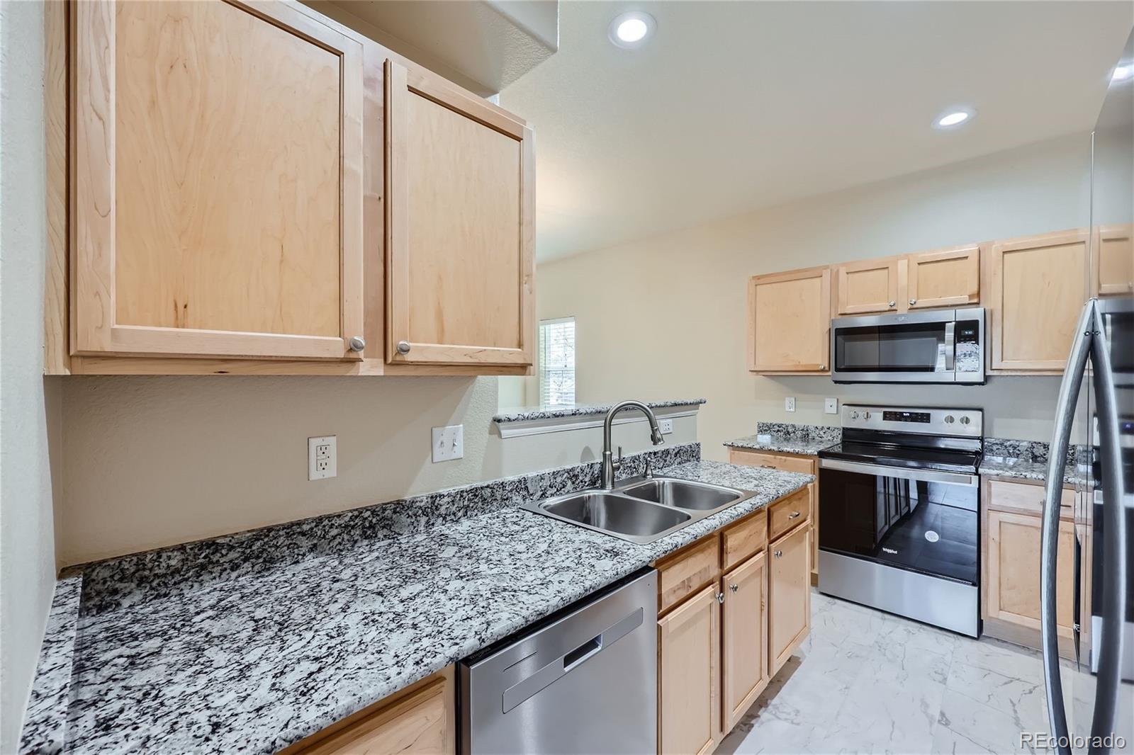 1515 Live Oak Road Castle Rock, CO 80104 - Photo 8 of 26 a kitchen with stainless steel appliances granite countertop a sink stove and refrigerator