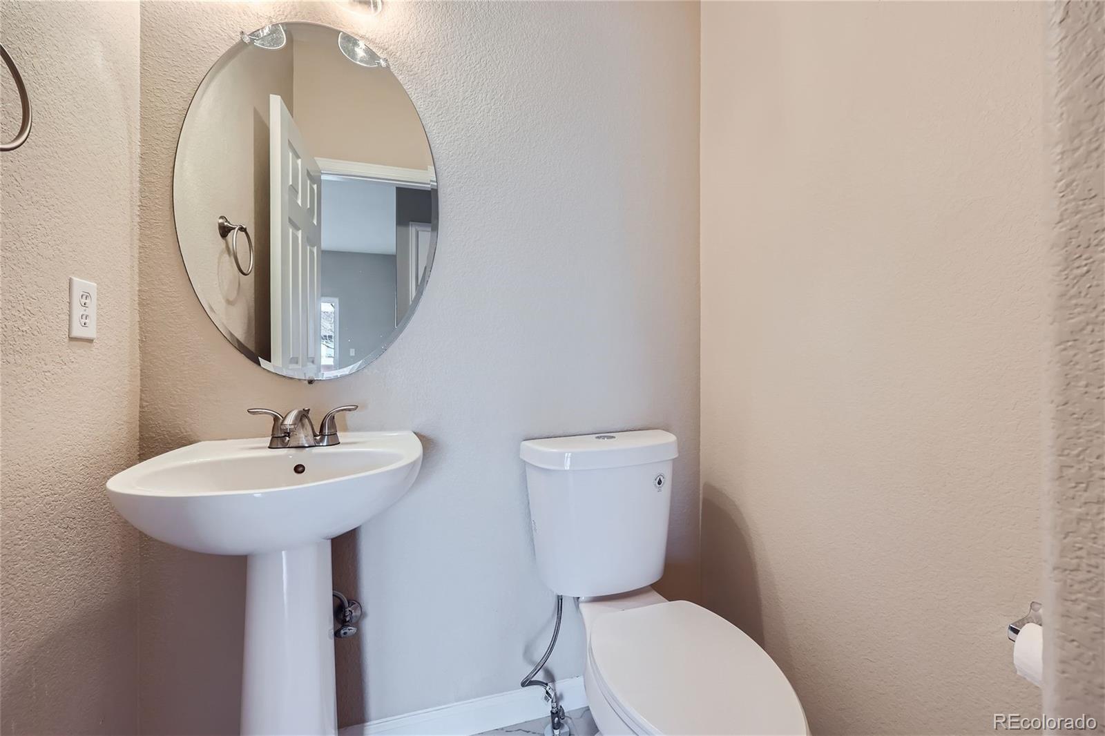 1515 Live Oak Road Castle Rock, CO 80104 - Photo 9 of 26 a bathroom with a toilet sink and mirror