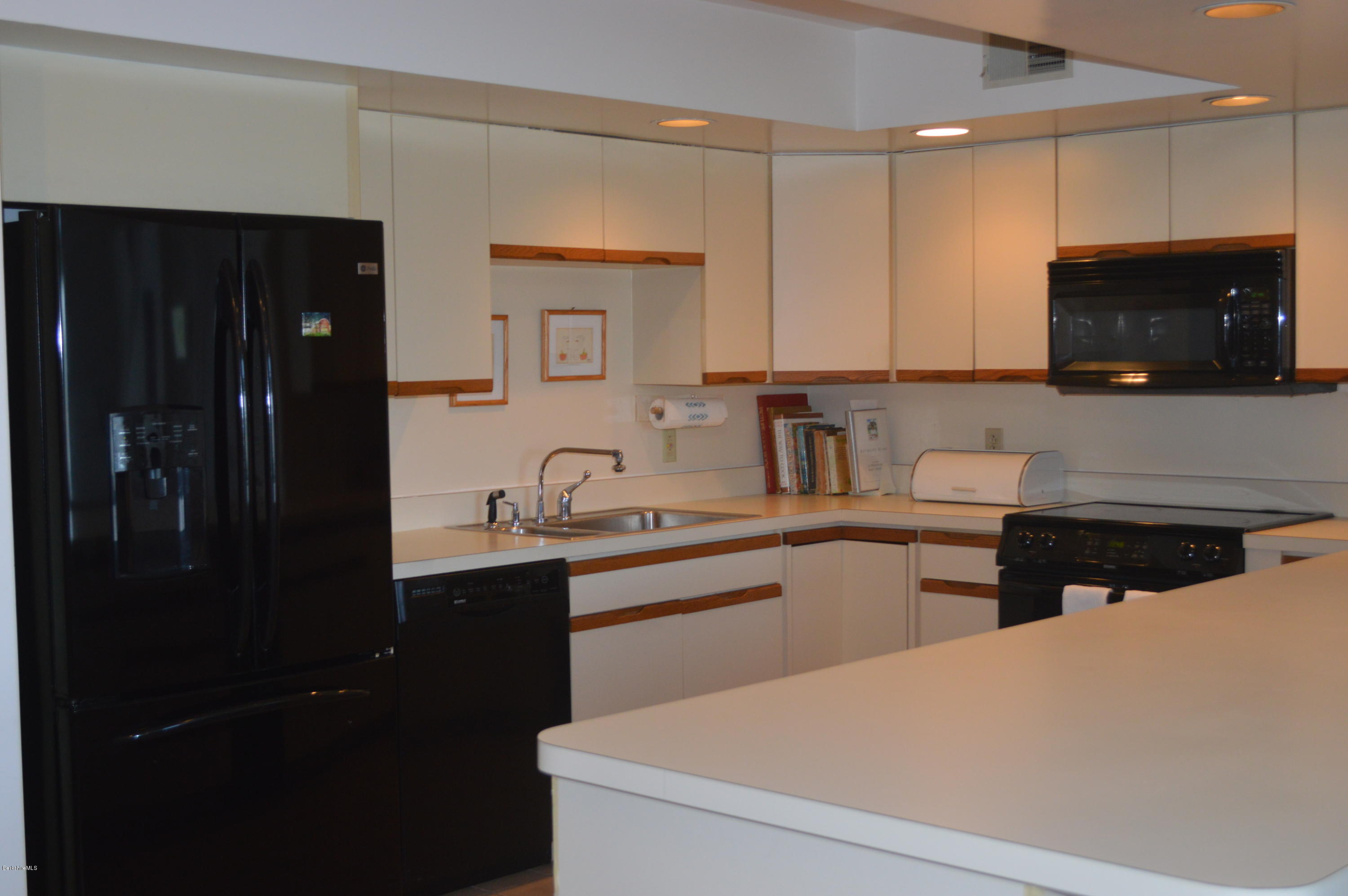200 Old Stockbridge Road Lenox, MA 01240 - Photo 11 of 30 a kitchen with stainless steel appliances a sink stove and refrigerator