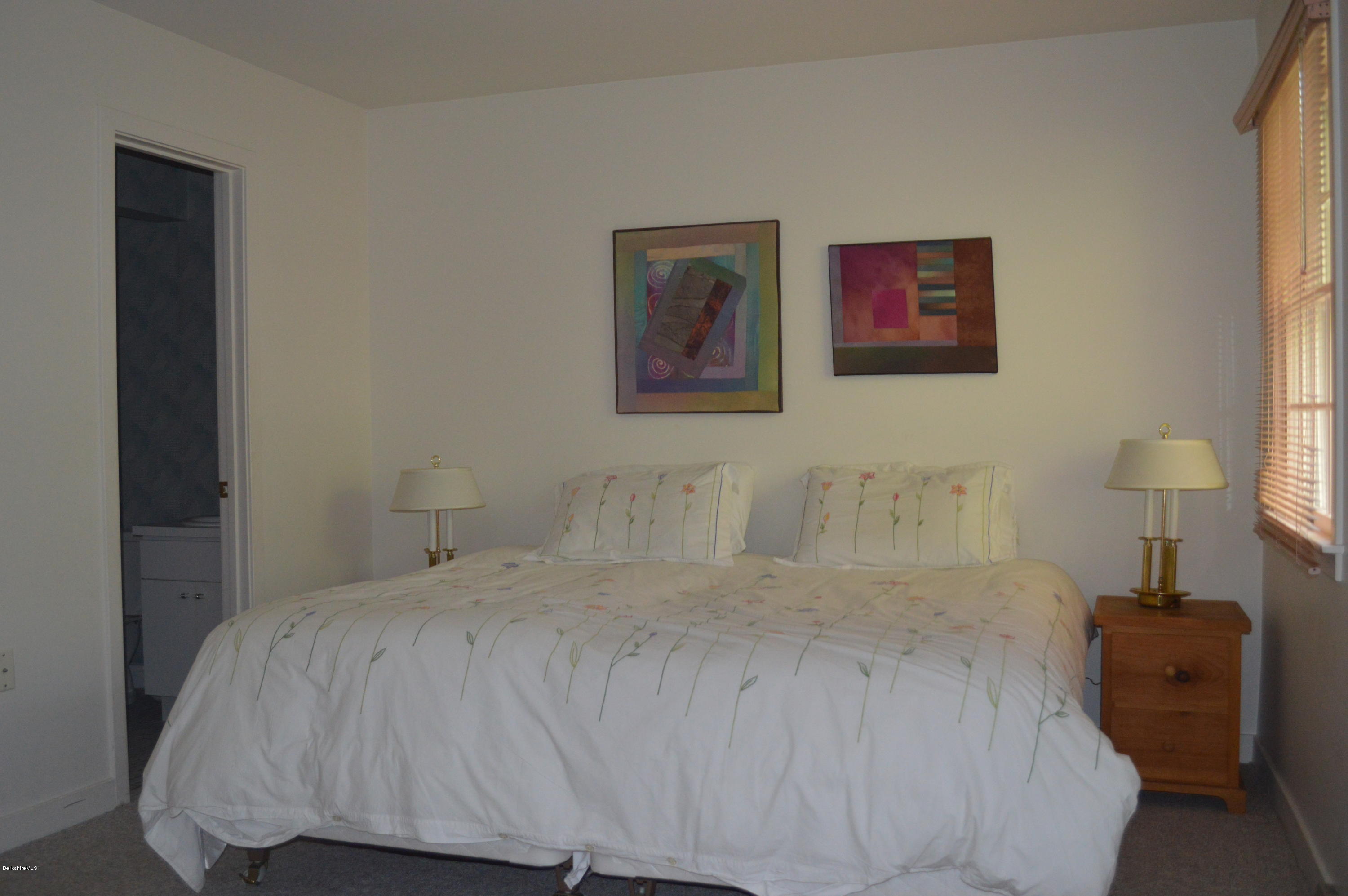 200 Old Stockbridge Road Lenox, MA 01240 - Photo 18 of 30 a bedroom with a bed and a lamp