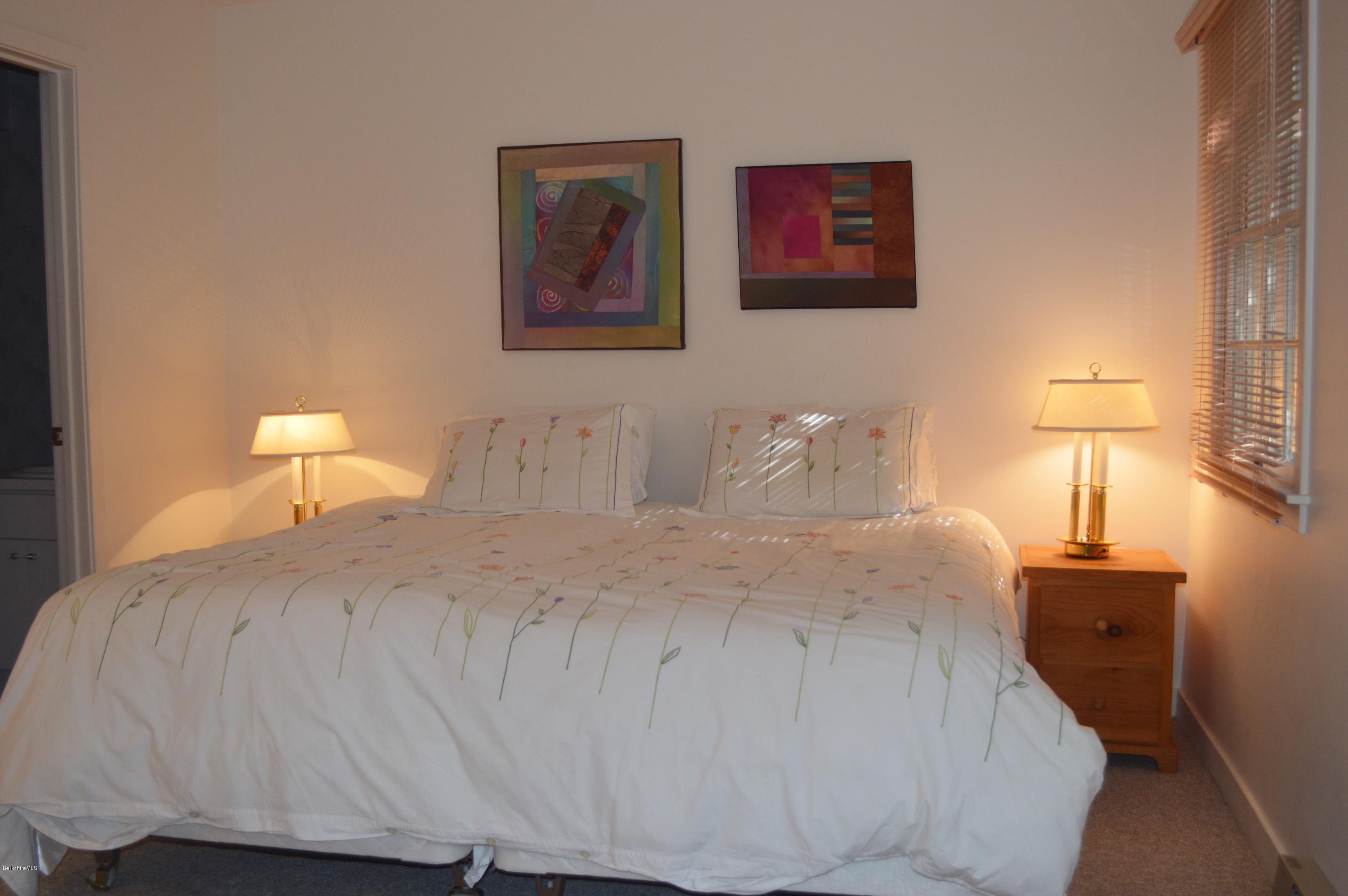 200 Old Stockbridge Road Lenox, MA 01240 - Photo 19 of 30 a bedroom with a bed and a lamp