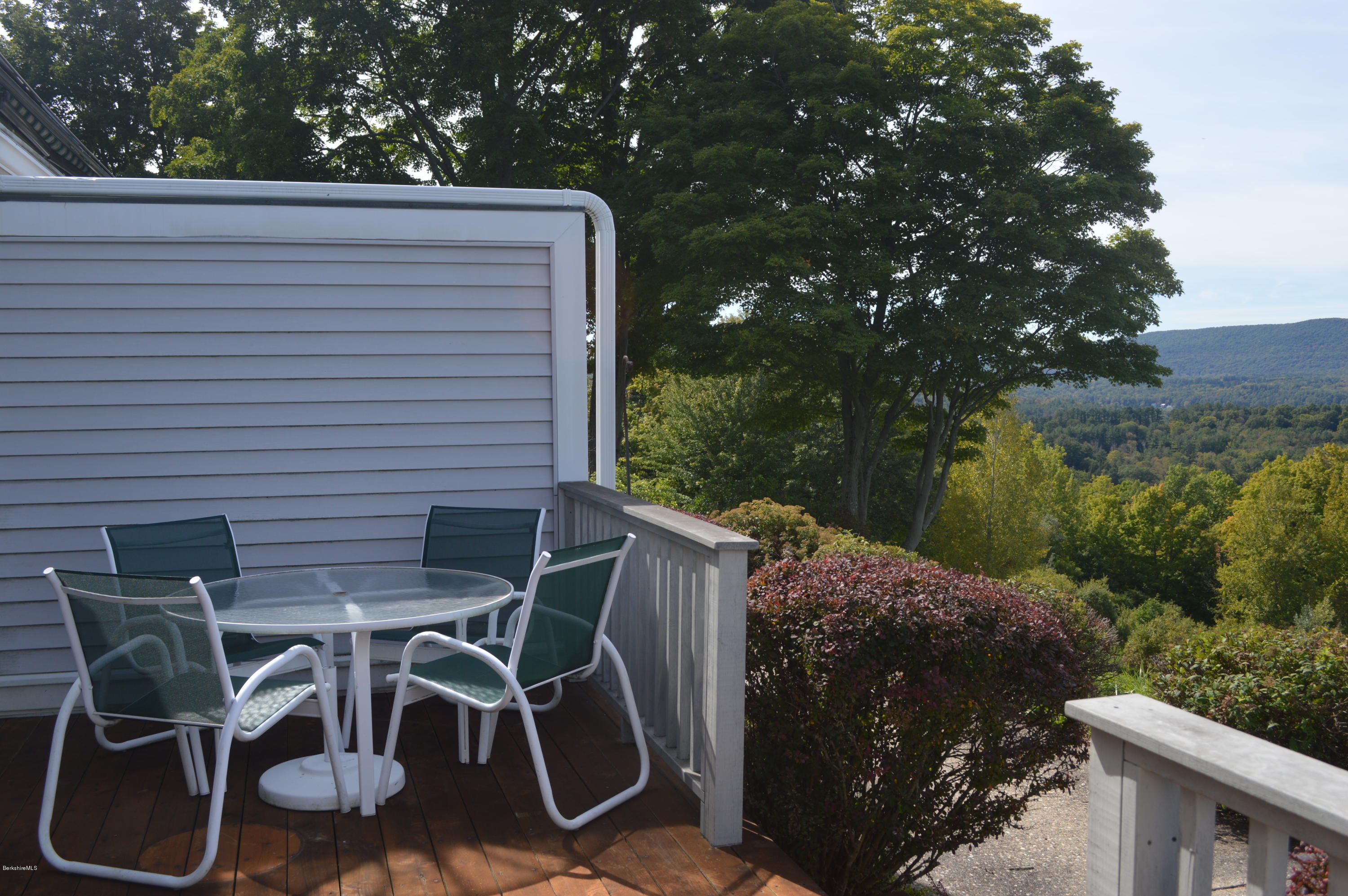200 Old Stockbridge Road Lenox, MA 01240 - Photo 24 of 30 a view of a patio with table and chairs with wooden fence